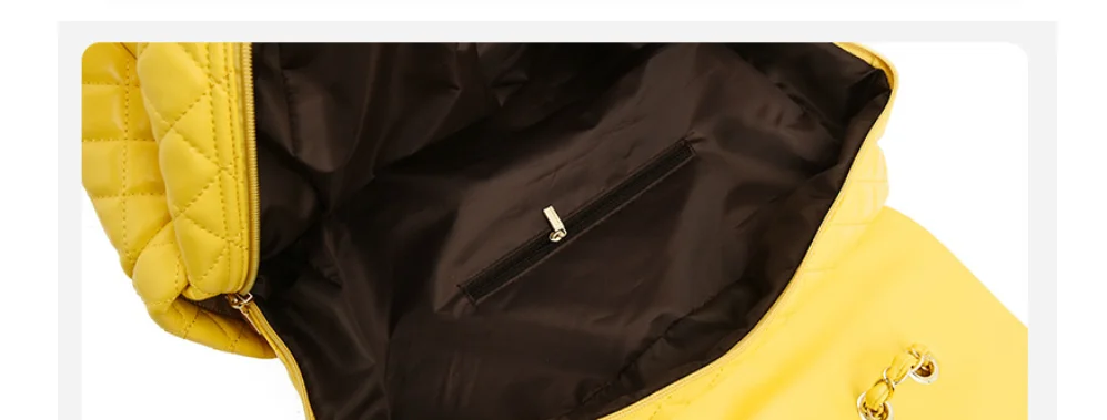 Yellow quilted travel bag interior, showing dark lining and a zippered pocket.