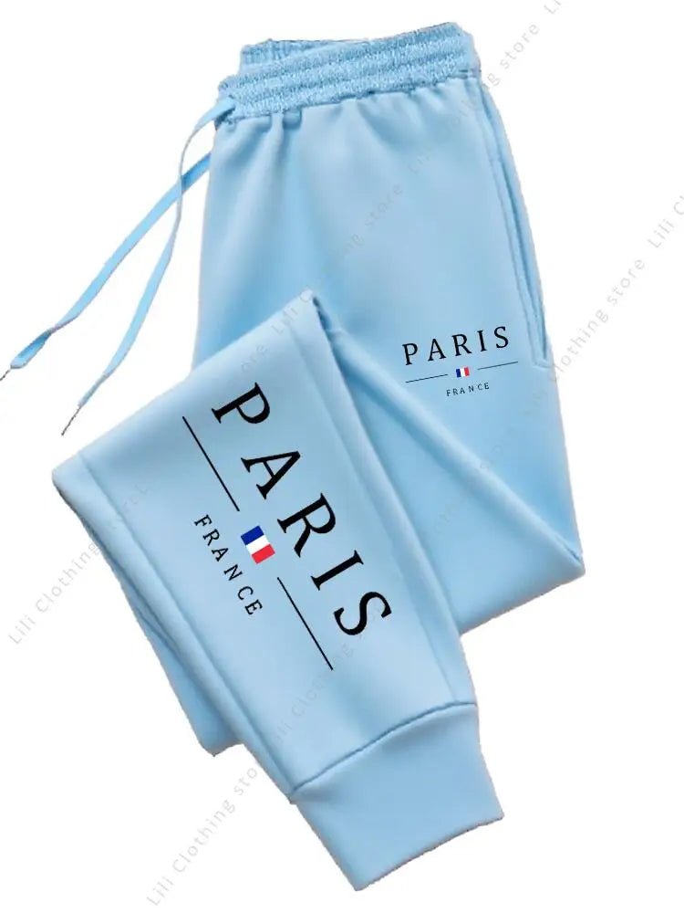 Light blue fleece lined stretchy jogger pants with Paris France print for comfortable lounge wear.