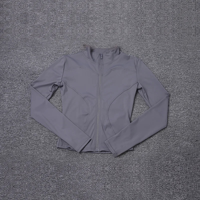 Grey fitted polyester sport jacket with long sleeves and zipper for yoga training.