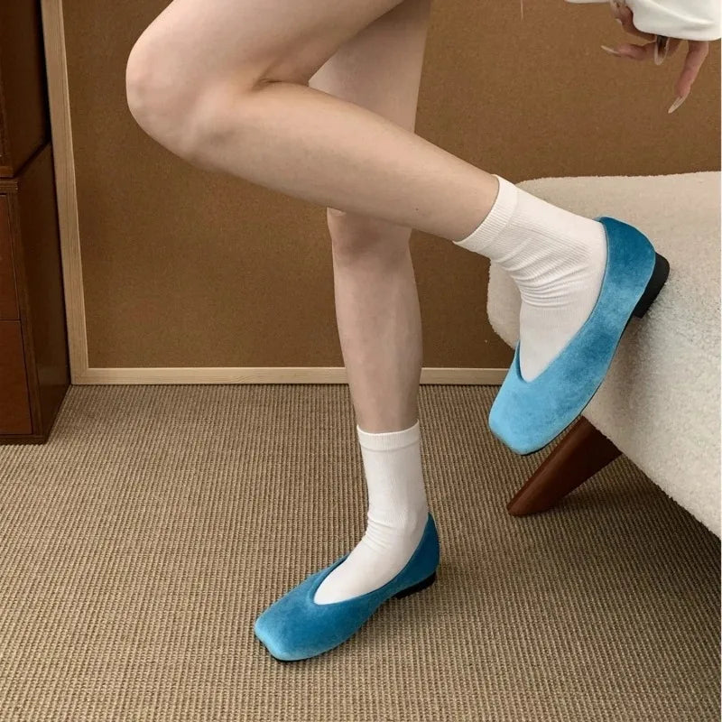 Bright blue suede square toe slip-on flats with a cushioned sole for comfortable daily wear.