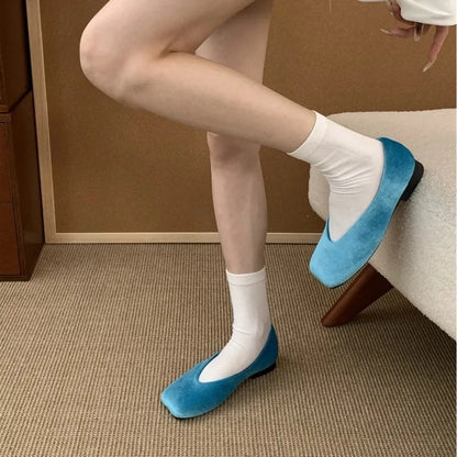 Bright blue suede square toe slip-on flats with a cushioned sole for comfortable daily wear.