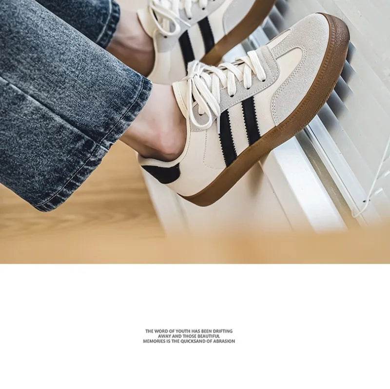 Off-white and black canvas sneakers with breathable gum soles for casual training.