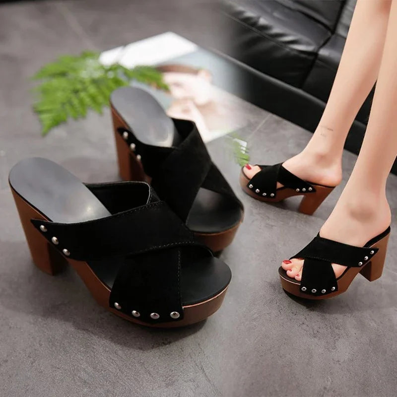Black flock platform sandals with silver rivets and wooden heels, a stylish platform shoe for evening outfits.