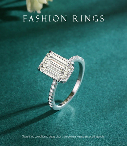 Silver ring with a large rectangular emerald-cut zirconia center stone and pavé-set stones along the band.
