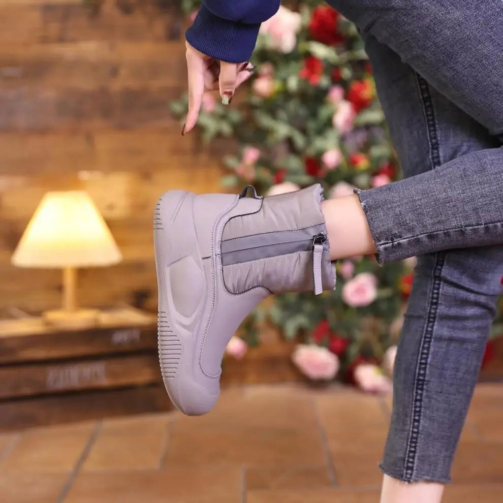 Grey waterproof short winter boot with a side zipper, thick sole, and padded upper material.
