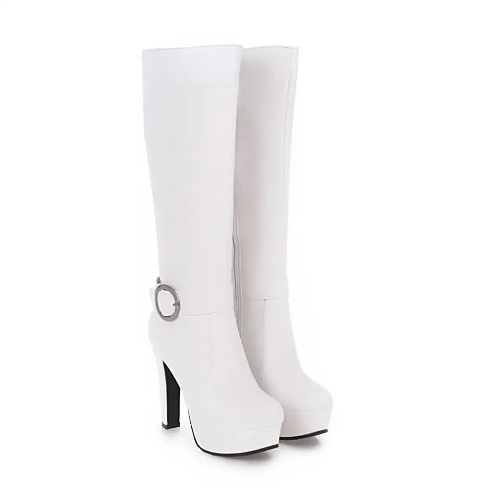White faux leather knee-high platform boots with high heels, side zippers, and ankle strap with round buckle.