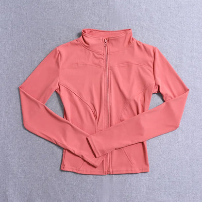 Coral pink fitted long sleeve jacket with a front zip and seams for gym training or yoga.