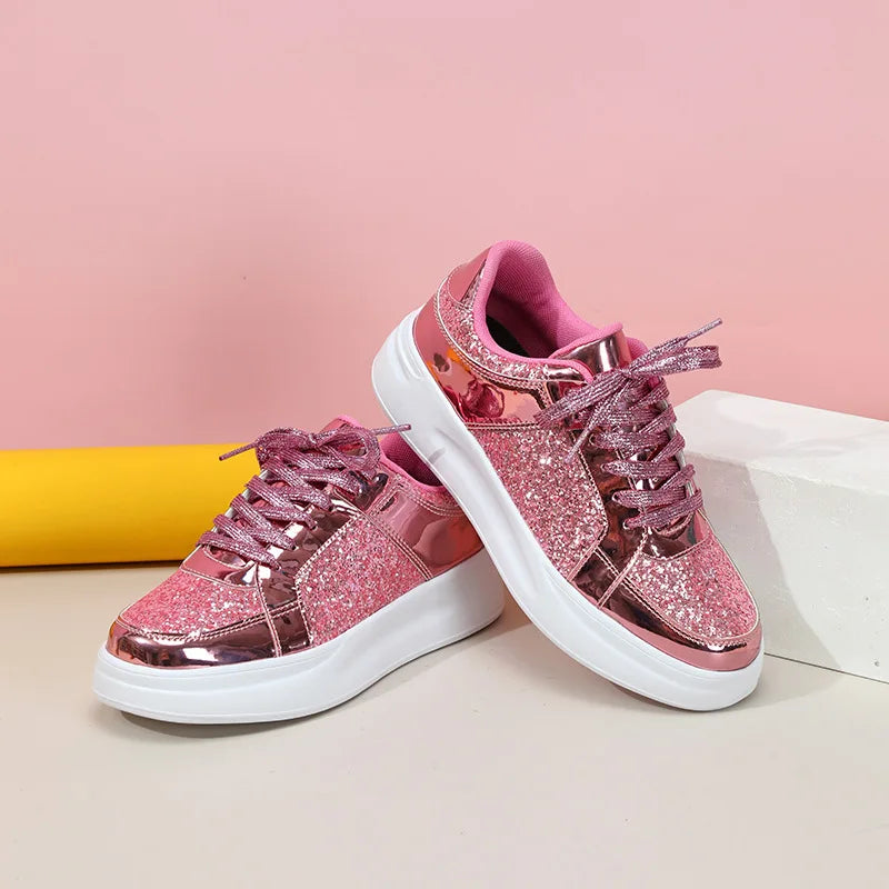 Pink lace-up platform sneakers with metallic panels, glitter sides, and thick white soles.