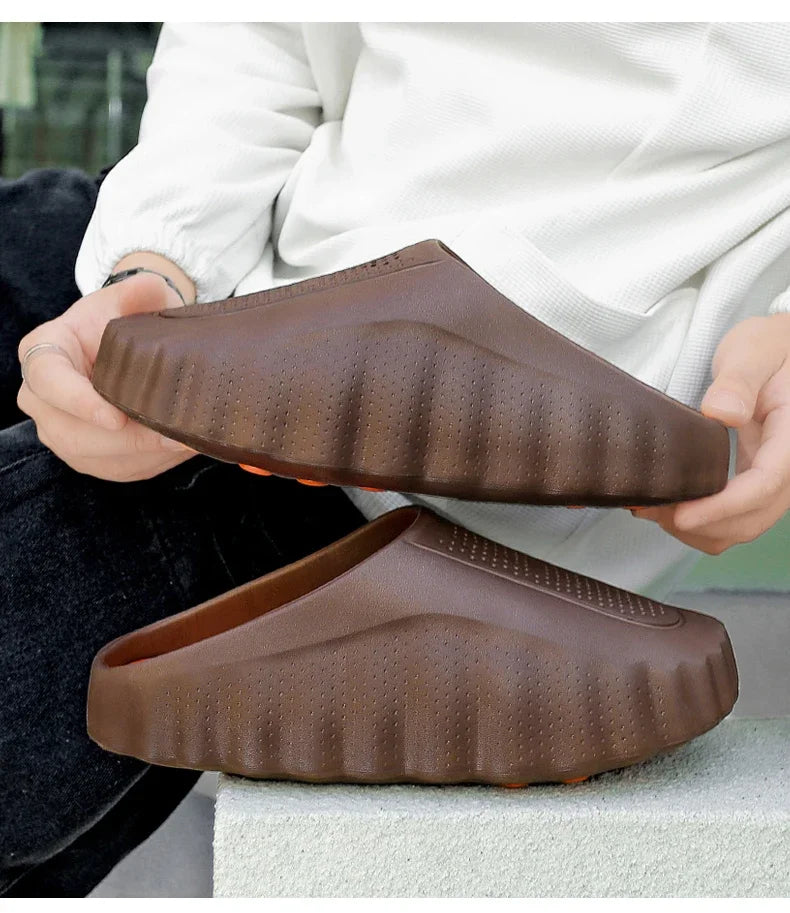 Brown, perforated slip-on sandals with a ridged platform sole for cushioned support during long days.