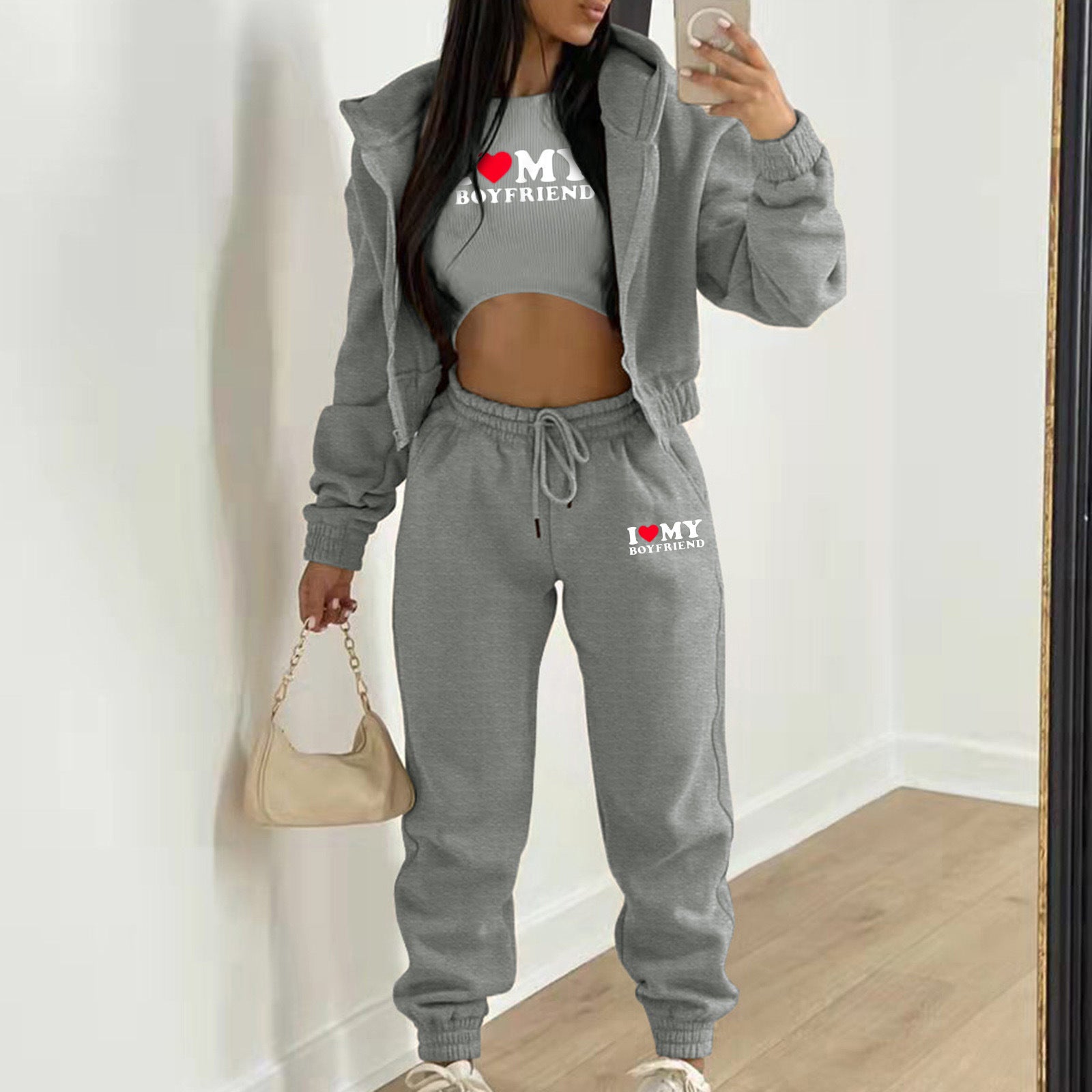Grey knit sweater set with hooded jacket and high waist joggers for lounging. Letter print details on a relaxed fit.