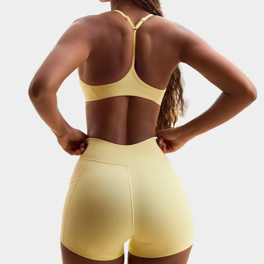 Women's yoga set workout outfit with a halter sports bra and high-waisted shorts, back view