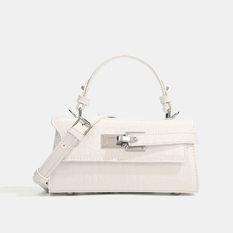 White crocodile-embossed faux leather structured crossbody with silver metal lock for daily essentials.