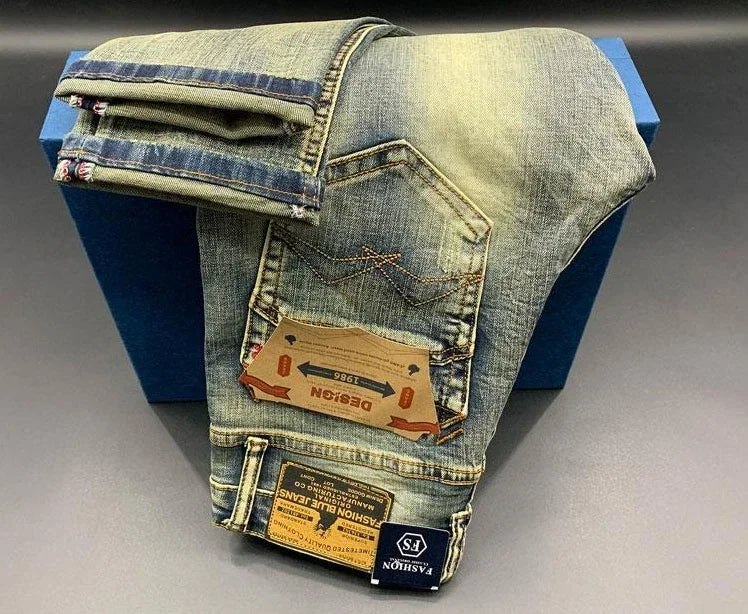 Light blue distressed denim tapered jeans with pockets and tan leather tags for daily comfort.