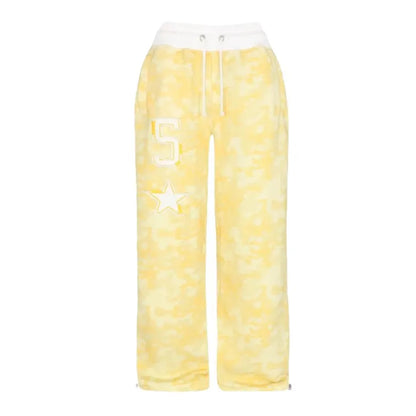 Yellow camouflage loose pants with a white waistband, letter S, and star patch for comfortable casual wear.