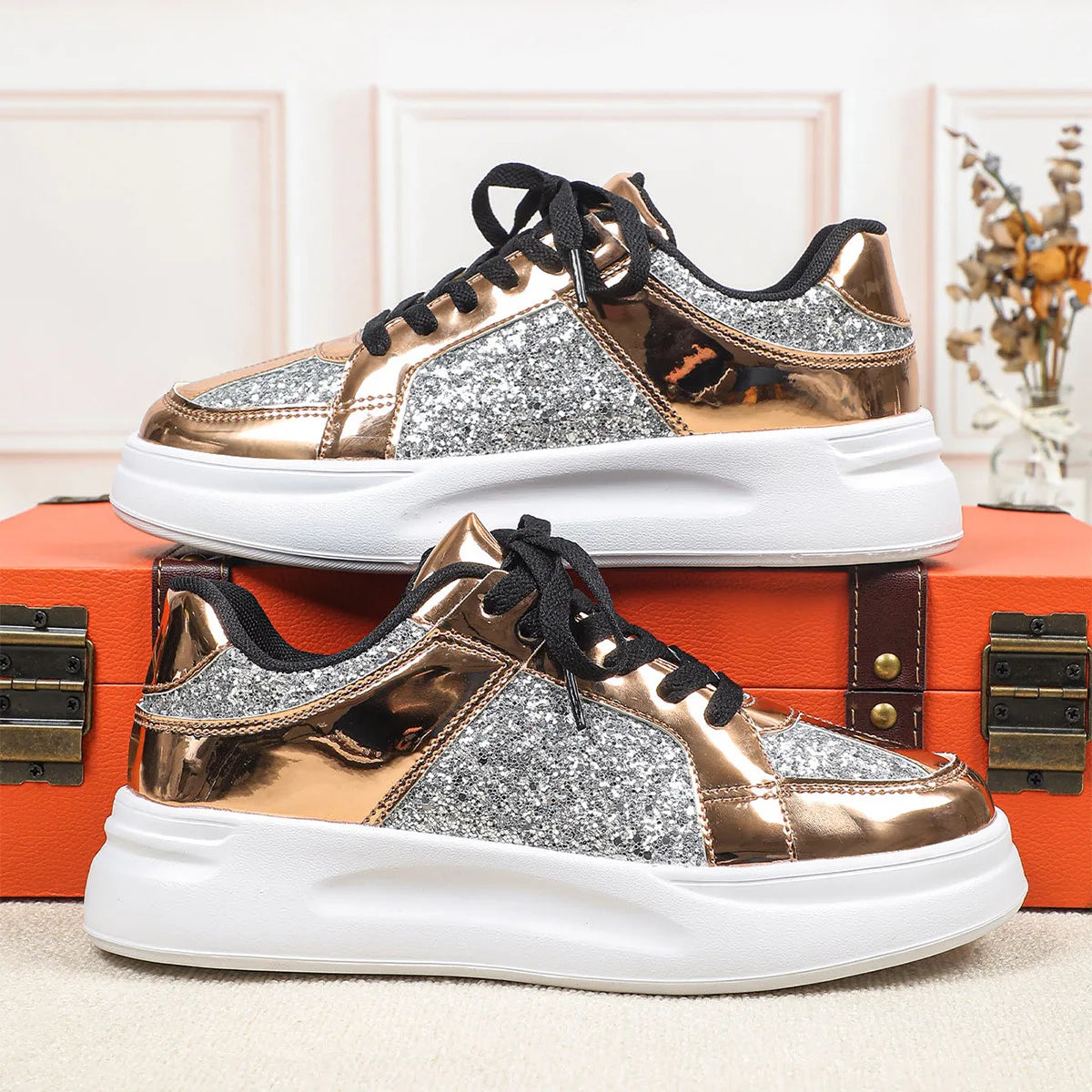 Rose gold and silver sequin lace-up sneakers with chunky white soles.
