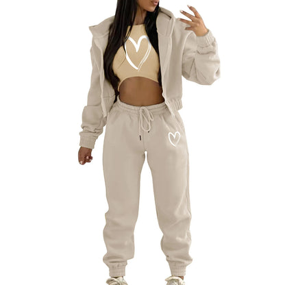 Beige knit sweater set with white heart print, hooded jacket and high waist joggers for a comfortable lounge outfit.
