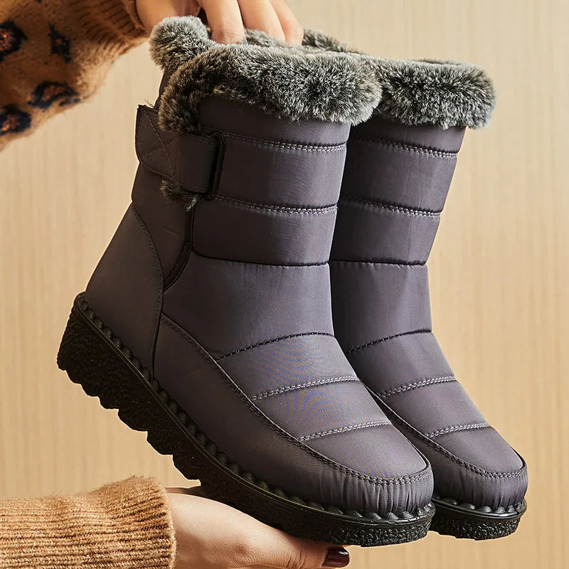 Gray waterproof winter snow boots with quilted nylon, faux fur trim, and a side strap.