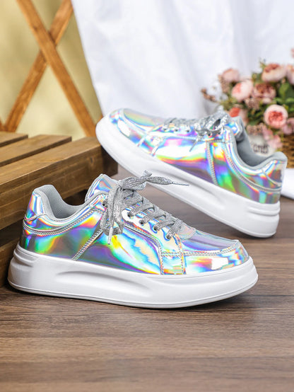 Silver holographic lace-up casual sneakers with thick white soles and glittery silver laces.