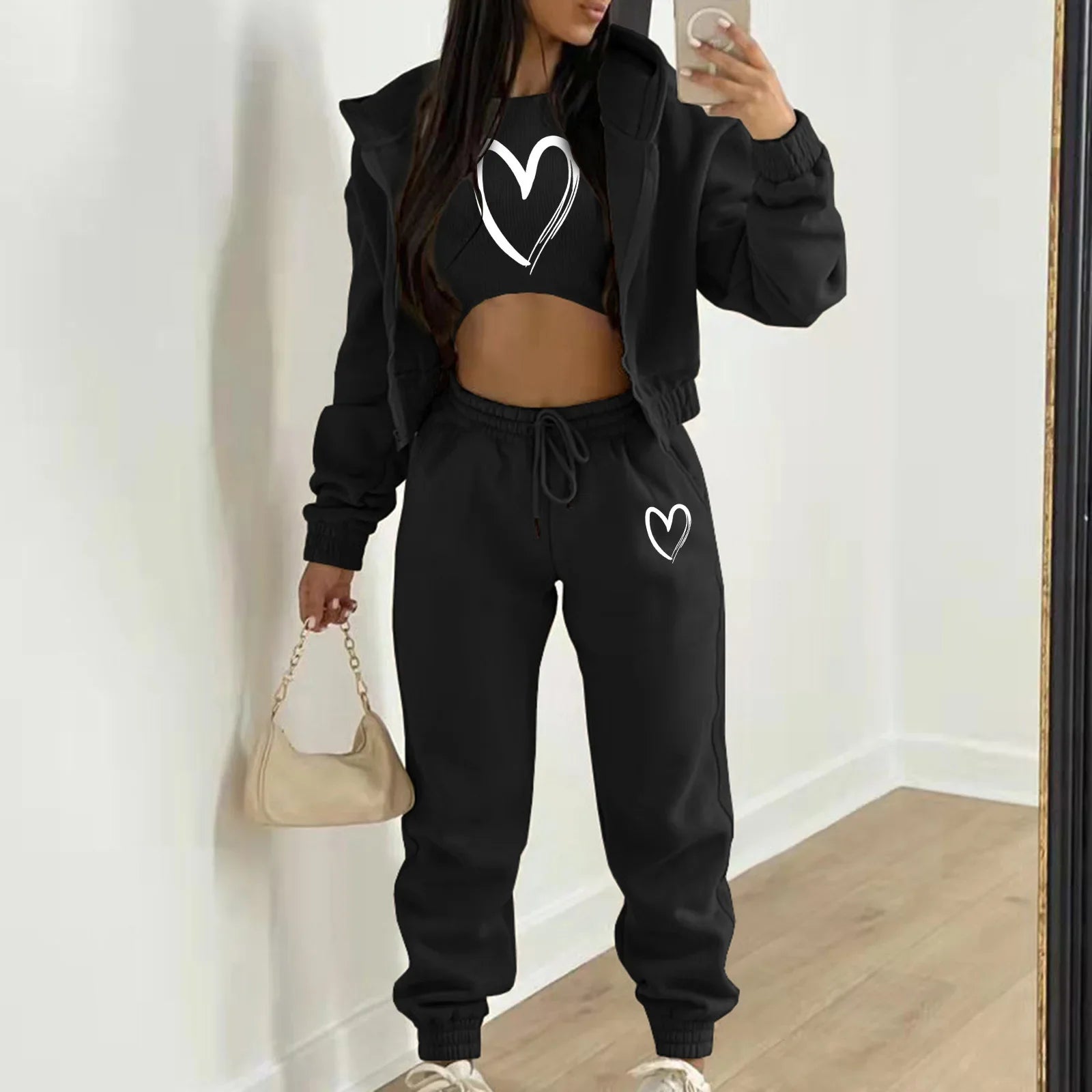 Black plush knit sweater set with white heart prints, hooded zip jacket, and relaxed high waist pants for loungewear.