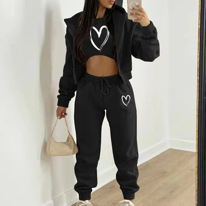 Black plush knit sweater set with white heart prints, hooded zip jacket, and relaxed high waist pants for loungewear.