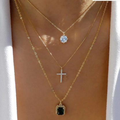 Layered necklace set featuring a cross pendant and rhinestones