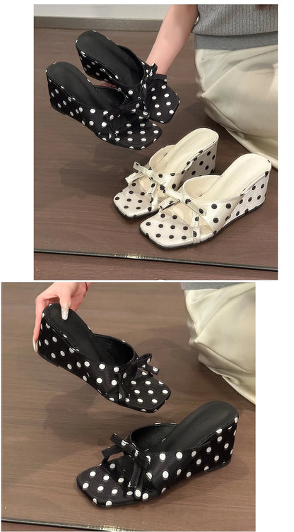 Black and white polka dot wedge sandals with a front bow detail and cushioned insole for casual wear.