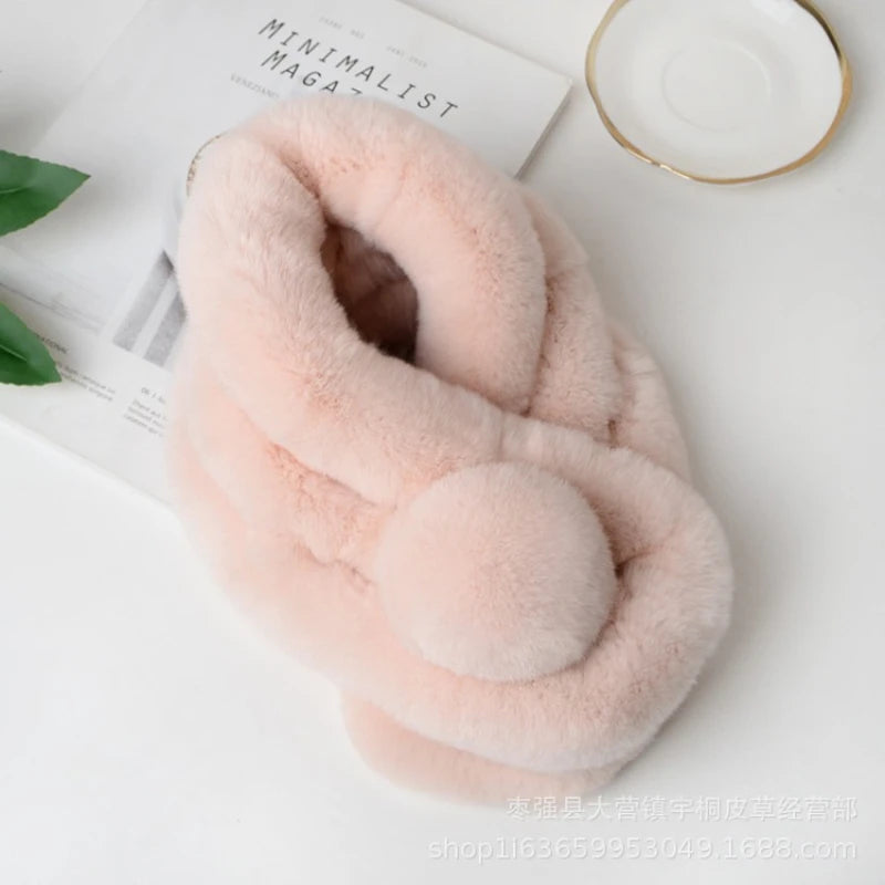 Short light pink rabbit fur scarf with a triple tube design and pom pom detail.