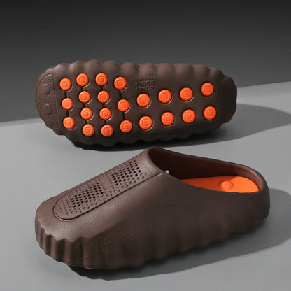 Brown EVA sandals with orange massage soles and perforated design are cushioned slip-on shoes for casual wear.