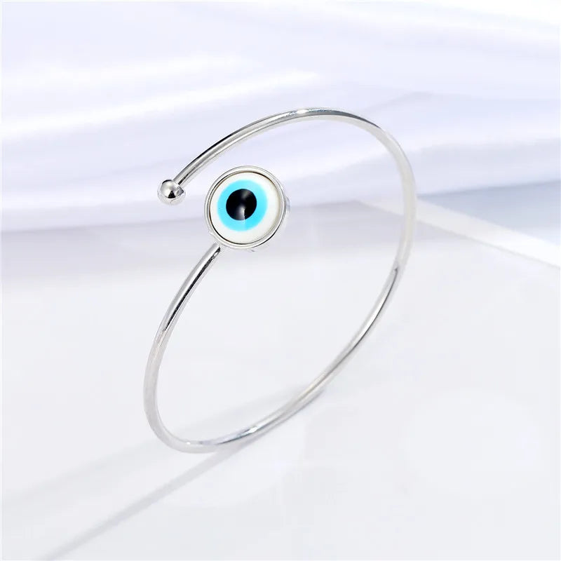 Adjustable cuff bracelet with a geometric evil eye motif