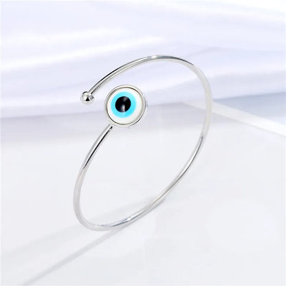 Adjustable cuff bracelet with a geometric evil eye motif