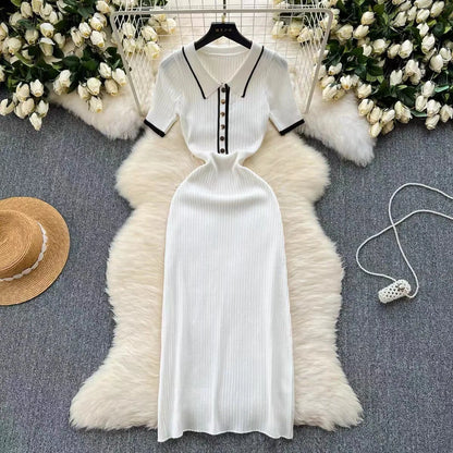 White ribbed knit fitted polo dress with black trim and buttons for a casual day look.