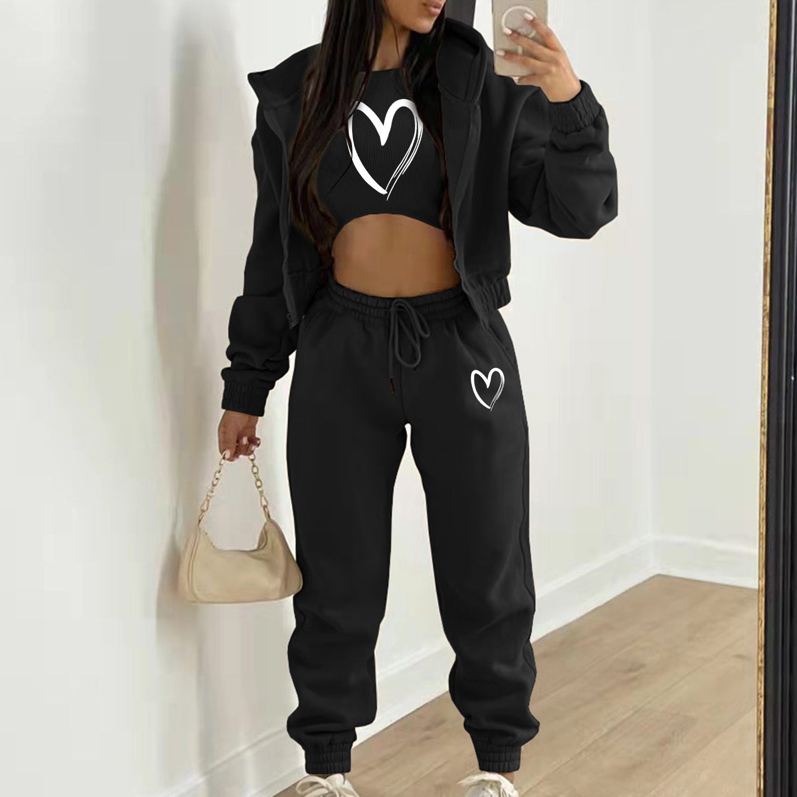 Black knit sweater set with white heart print and relaxed fit, cozy for casual wear.