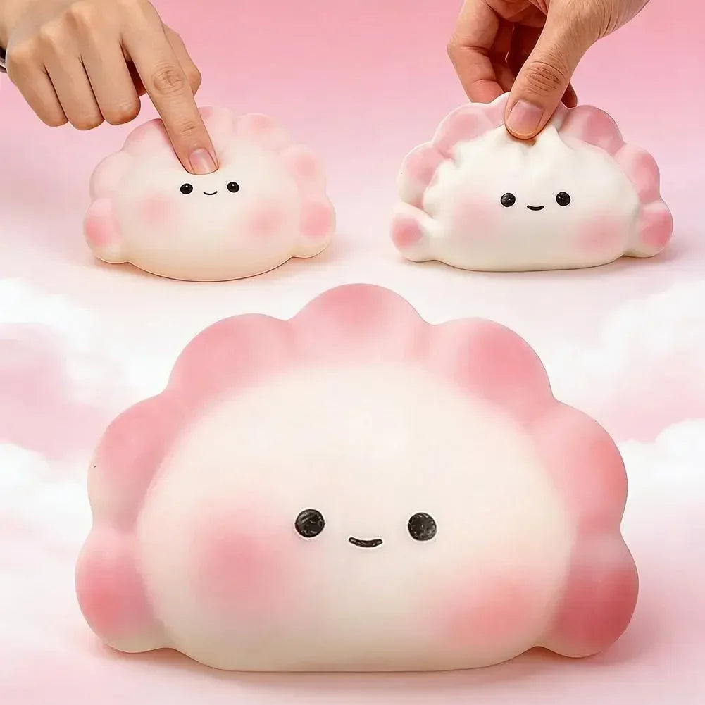 White and pink dumpling squishy fidget toy with a smiling face for stress relief.