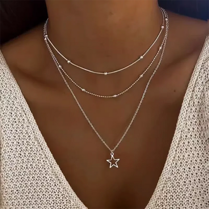 Women's gold-tone layered chain necklace with pendant detail