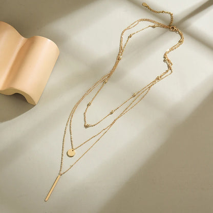 Women's gold-tone layered chain necklace with pendant detail