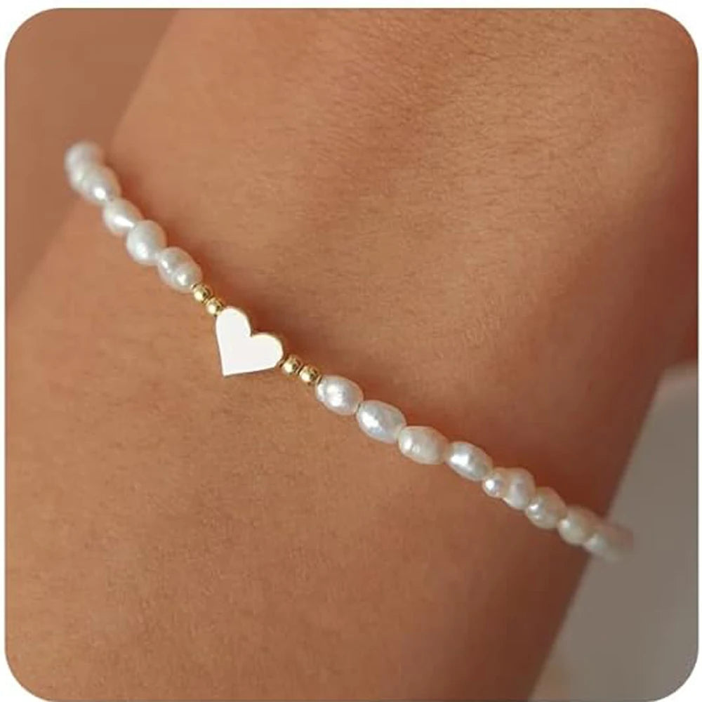 Women's pearl bracelet with heart and evil eye charms