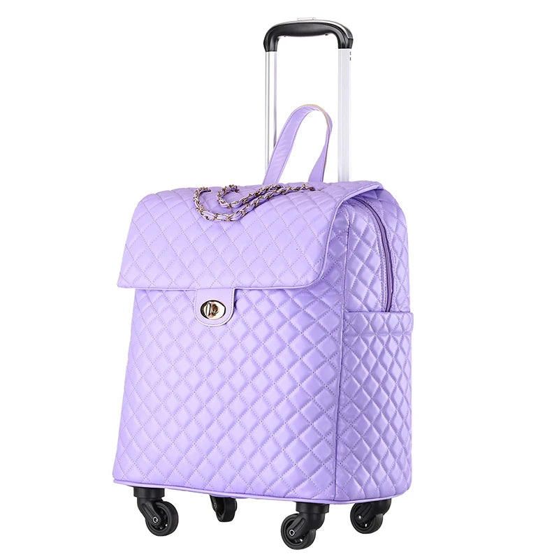 Purple quilted PU rolling suitcase with a front flap, gold turn-lock, chain detail, and a telescoping handle.