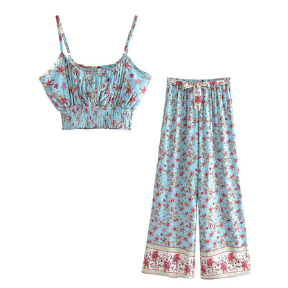 Light blue floral flowy two-piece set with a smocked crop top and drawstring wide leg pants for beach vacation.