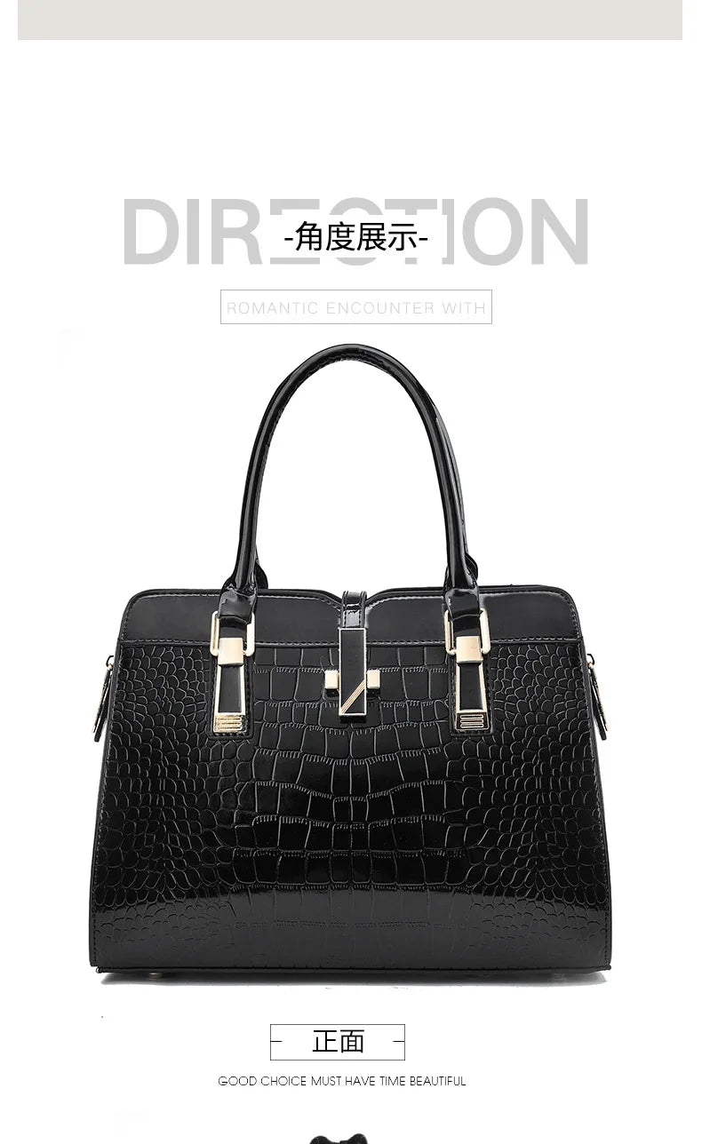 Black faux leather crocodile pattern tote bag with dual top handles, gold hardware, and a center clasp.