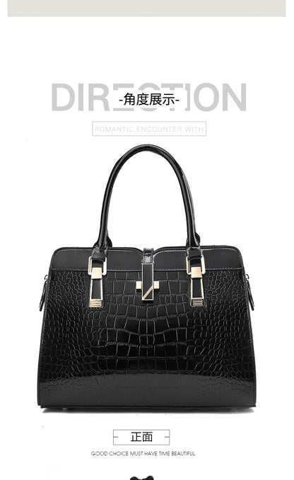 Black faux leather crocodile pattern tote bag with dual top handles, gold hardware, and a center clasp.