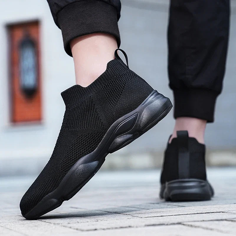Black breathable knit moccasin sneakers with a cushioned sole for casual daily wear.