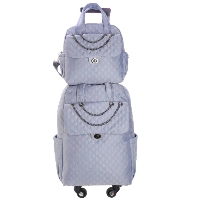 Gray quilted rolling backpack and matching handbag set with chain details and twist-lock closures.