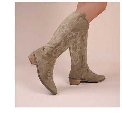 Taupe suede western cowboy boots with pointed toes, block heels, and white embroidery details.
