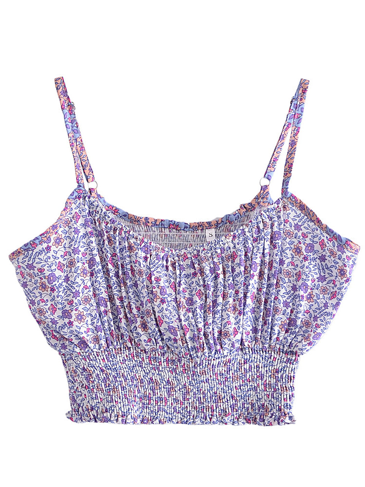 White floral print crop top with purple accents, spaghetti straps, and a stretchy, fitted, shirred bodice for summer.