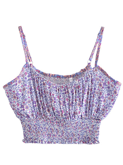 White floral print crop top with purple accents, spaghetti straps, and a stretchy, fitted, shirred bodice for summer.