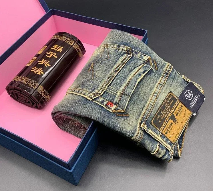 Blue, midweight, stretch denim tapered jeans with gold stitching and brand tags for comfortable daily wear.