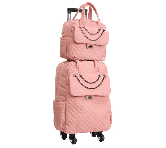 Pink quilted rolling luggage set with chain accents, top handles, and front flap pockets.