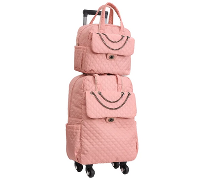 Pink quilted rolling luggage set with chain accents, top handles, and front flap pockets.