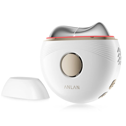 White electric facial massager with a contoured silver metal head and round gold control button.