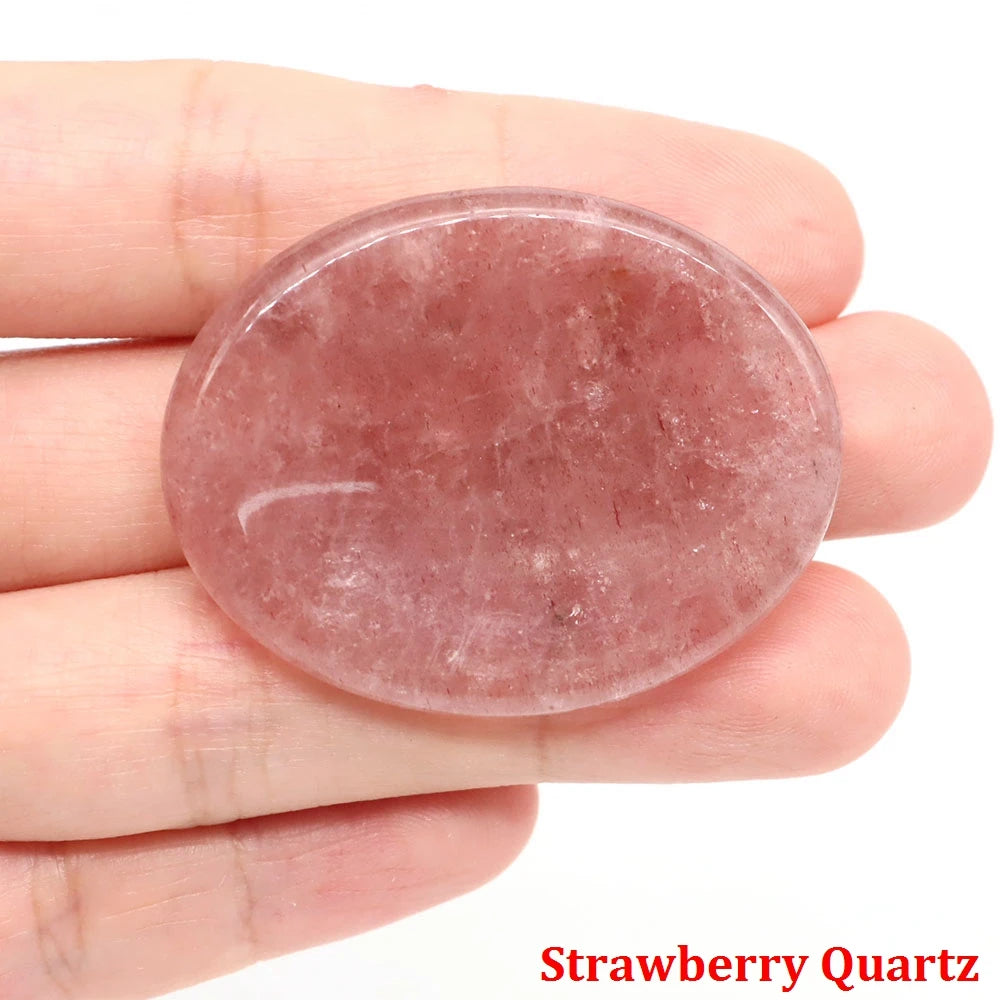 Smooth, oval pink strawberry quartz palm stone home decor for meditation.